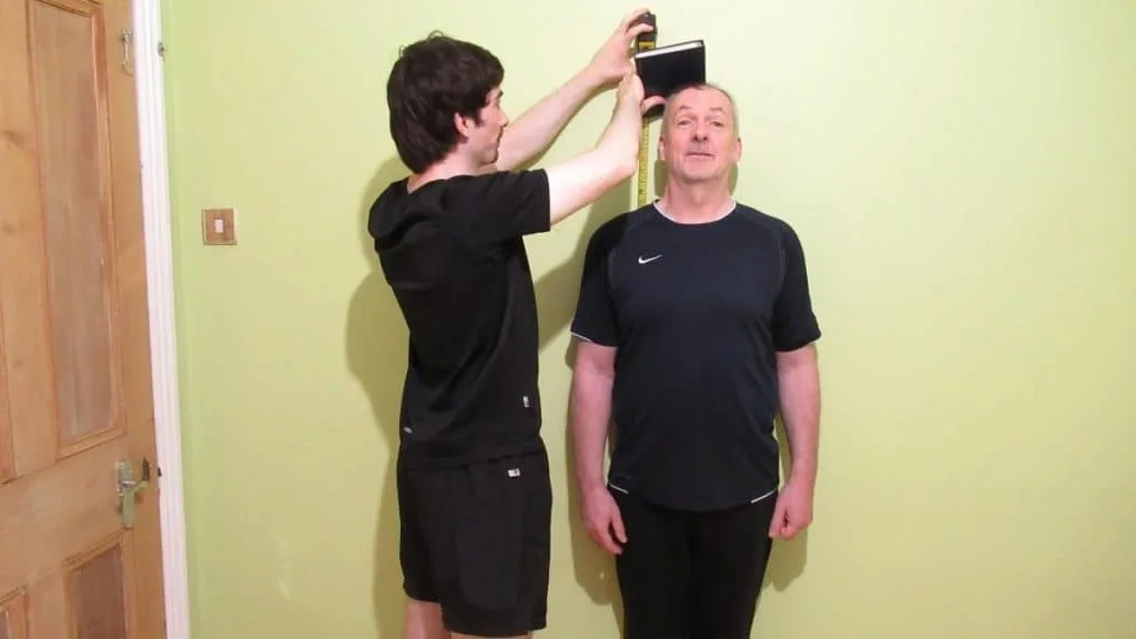 A man getting his height measured