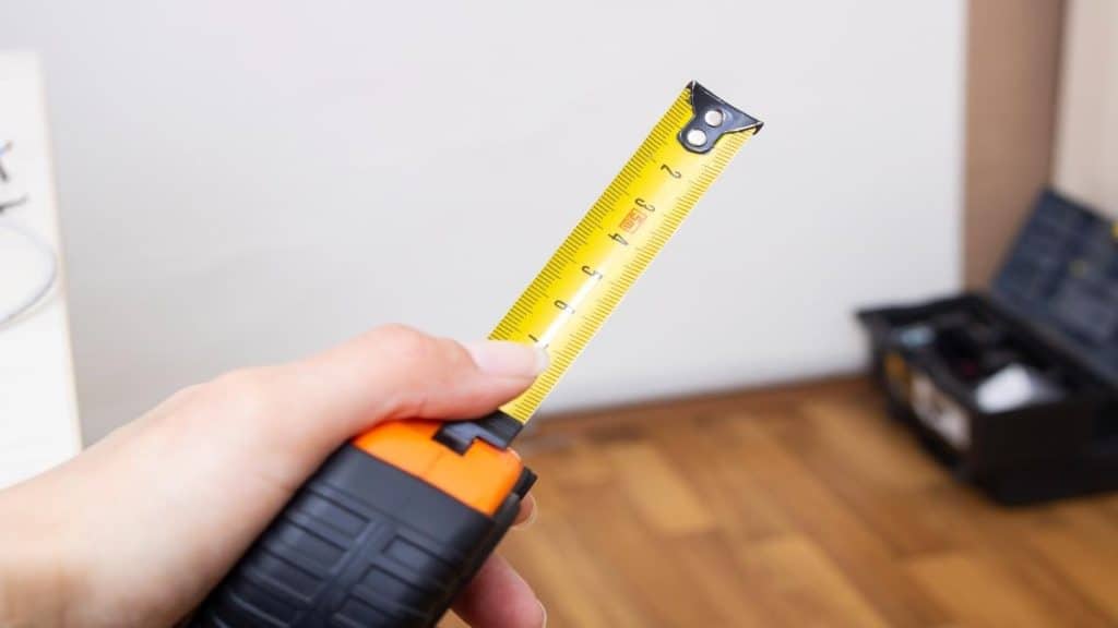 A person holding a tape measure