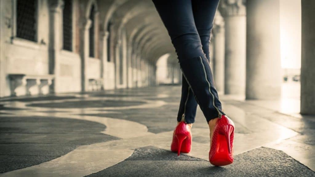 A woman wearing red high heels