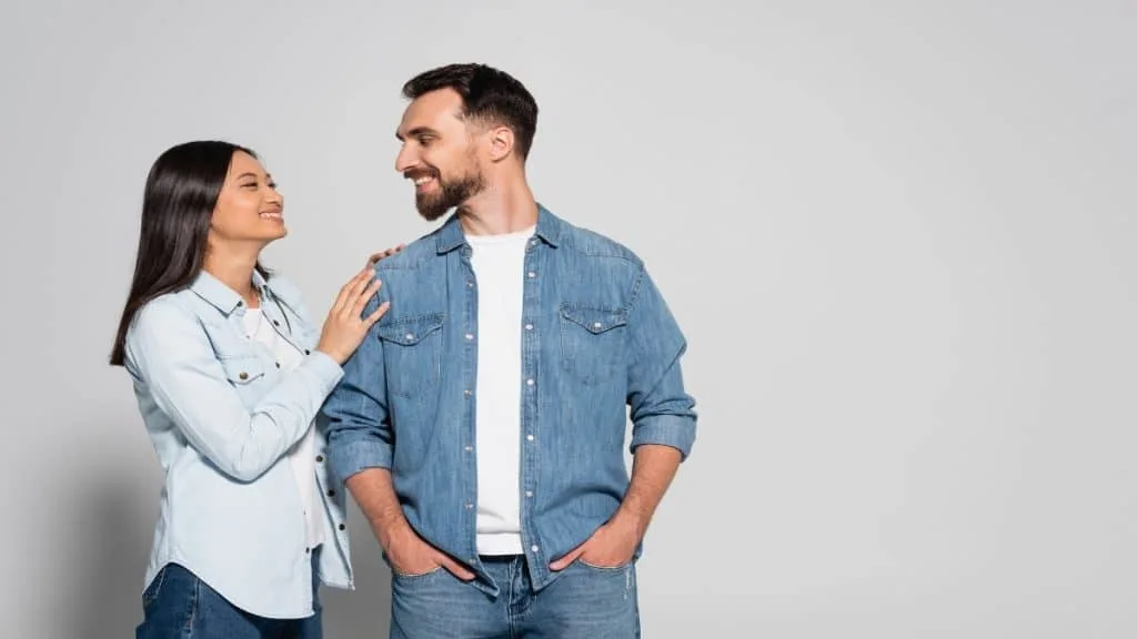 A woman grabbing the shoulder of her boyfriend