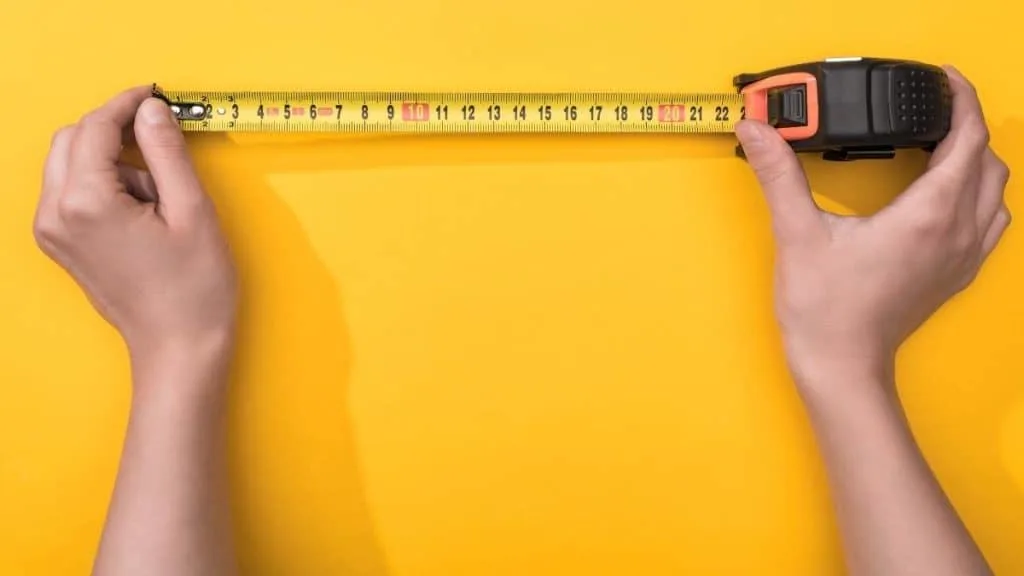 Person holding a measuring tape