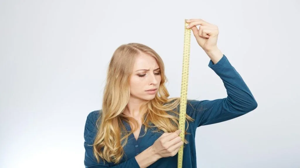 A woman holding a measuring tape