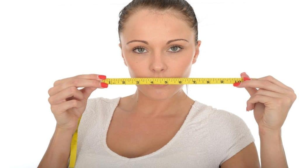 A woman holding a measuring tape
