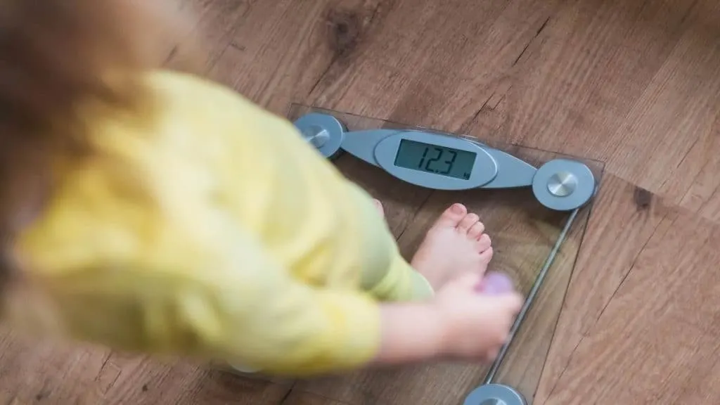 A woman standing on some weighing scales