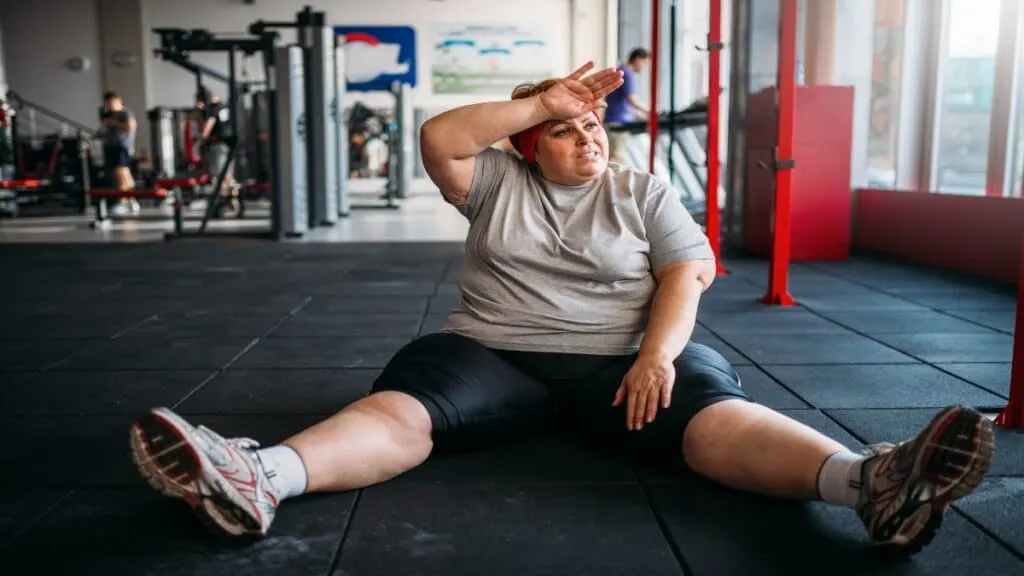 A fat 47 BMI woman doing a workout