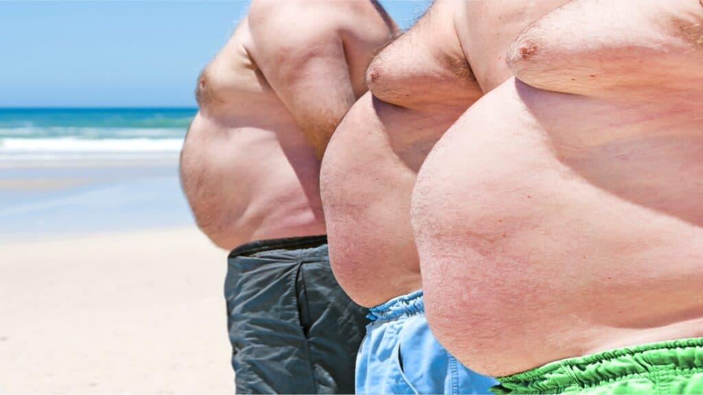 Some men who have a 55 BMI at the beach