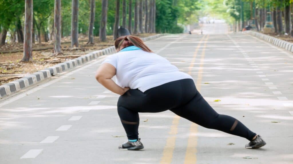 A 56 BMI woman doing some stretches