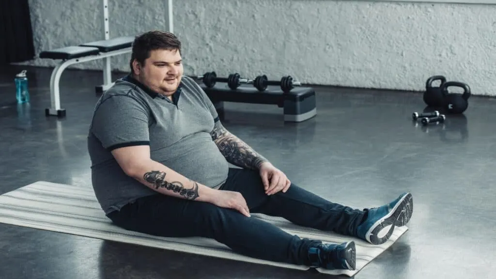 An overweight BMI 39 man at the gym