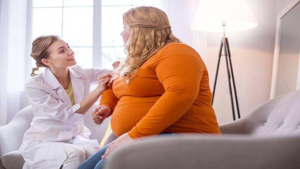 A fat BMI 47 female talking to a doctor