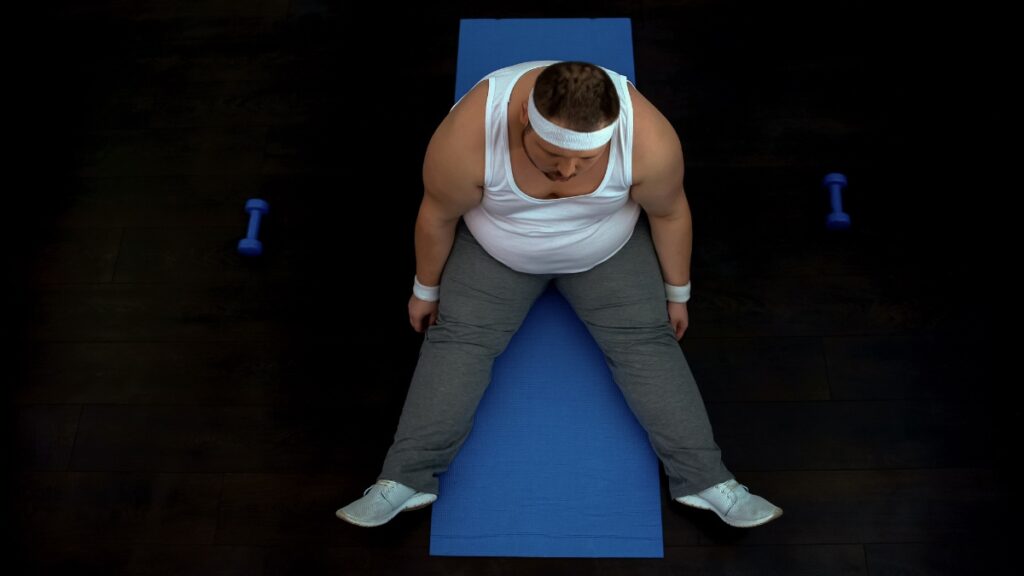 A BMI 57 man doing some exercise