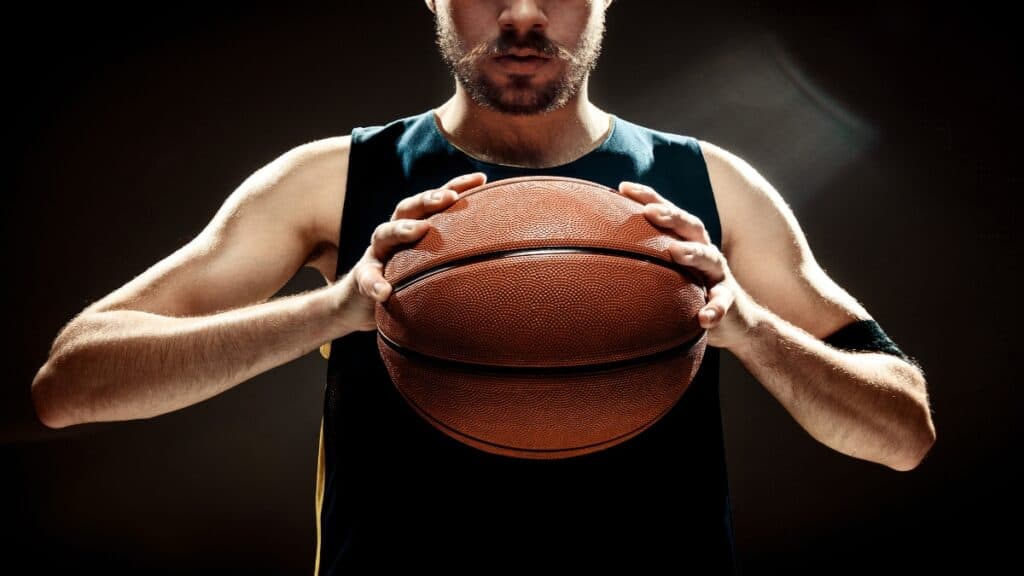 A 5'8 NBA player holding a basketball