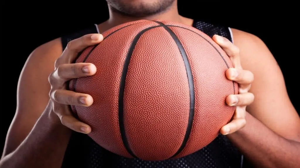 A 5'9 basketball player holding the ball