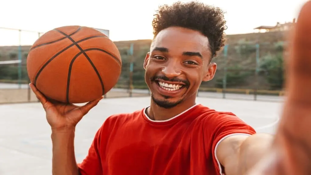 One of the best 6’10 players in the NBA holding a basketball