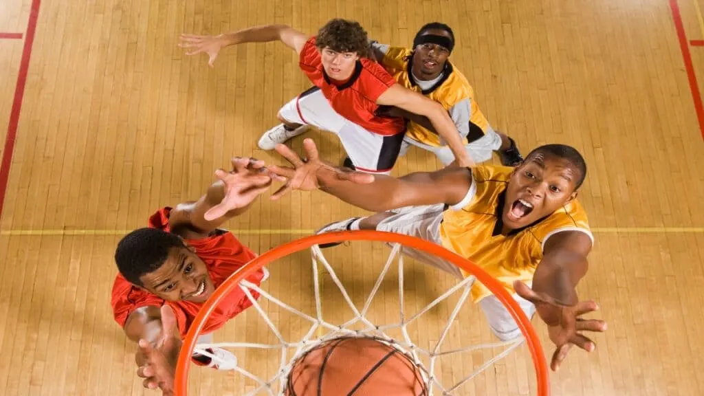 Some 6’5 basketball players on the court near the hoop