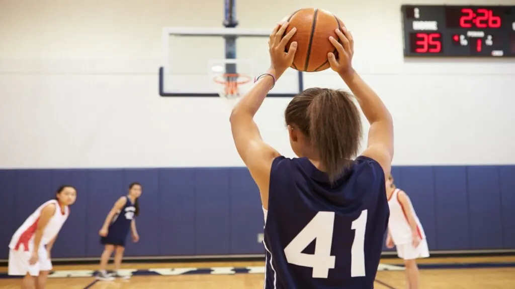 A 6’7 female basketball player on the court