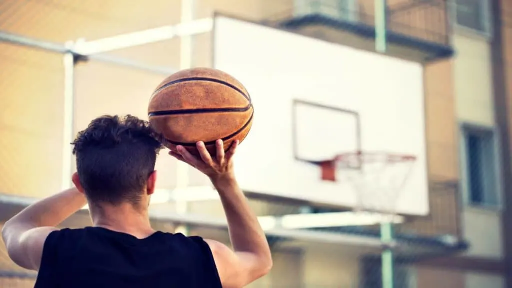 One of the best 6’9 basketball players throwing the ball towards the hoop