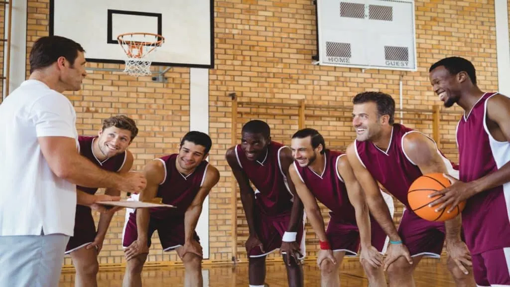 Some 6 foot 11 basketball players amongst their teammates