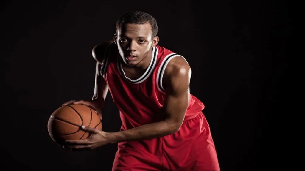 A 6 foot 8 basketball player passing the ball