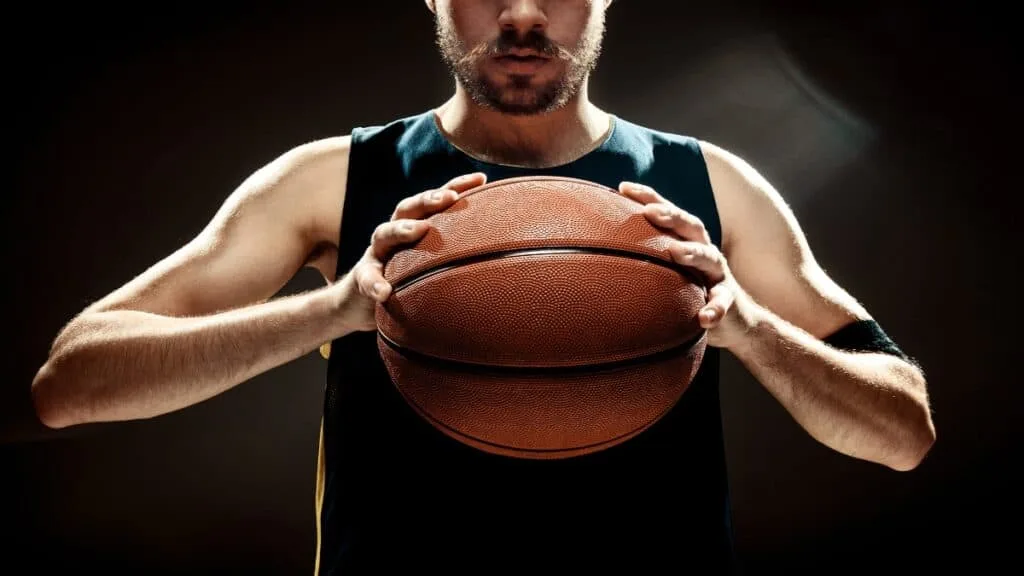 A 6 foot 9 basketball player holding the ball