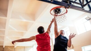 Some 7’1 NBA players reaching for the basketball and hoop