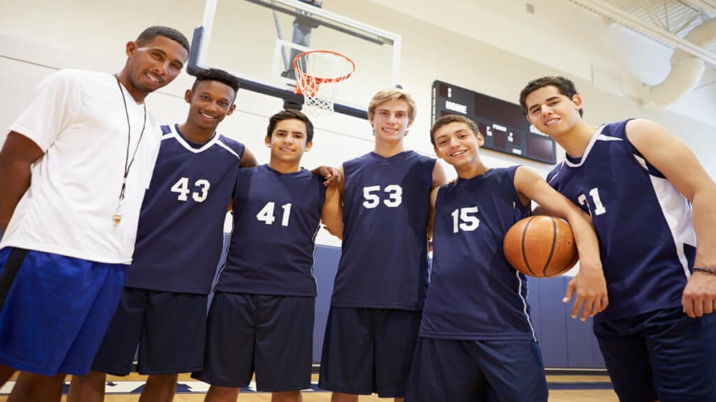 A group of basketball teammates demonstrating the average high school basketball player height