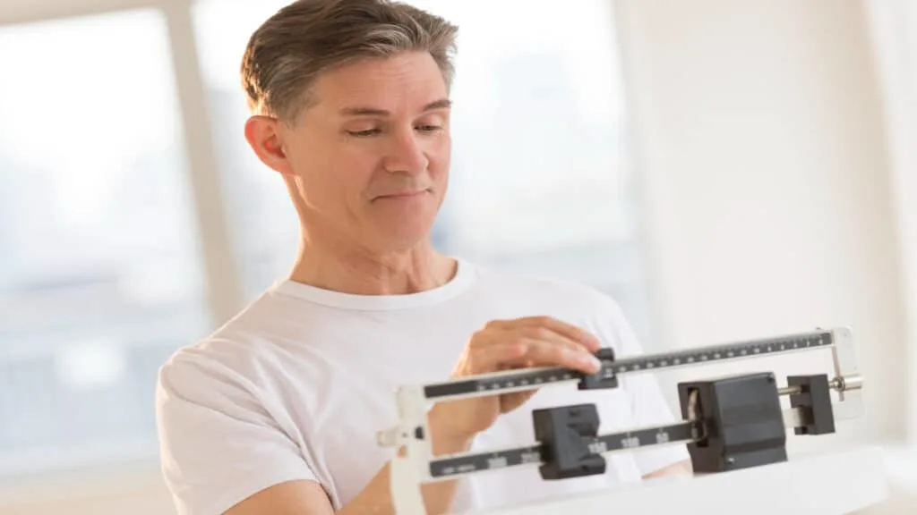 A man checking the average male weight by age