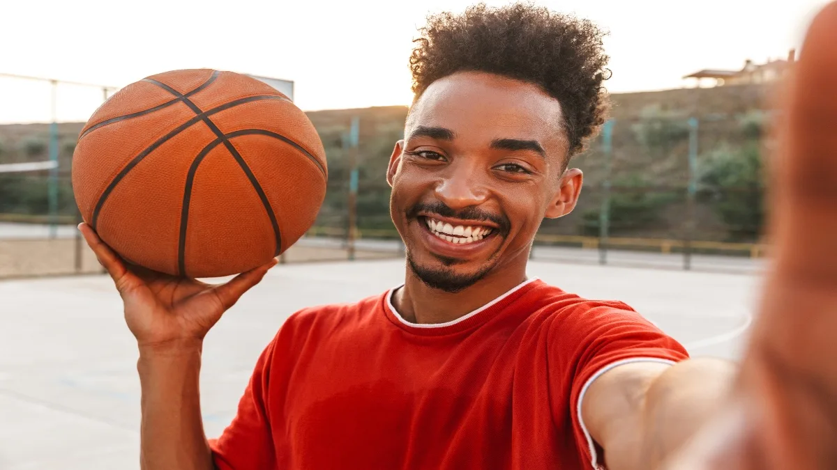 One of the best 6’4 NBA players holding a basketball