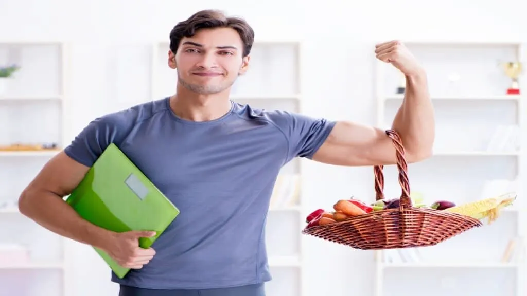 A man showing that he has a very healthy weight for a 6'2 male