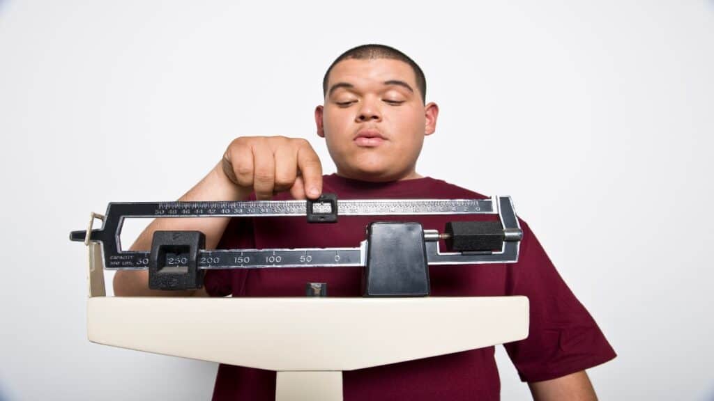 A man checking to see if he has the ideal weight for a 5'10 male